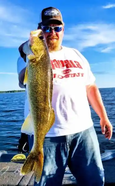 Scott Zupfer of Zup's Guide Service holding a walleye after a Northern Minnesota guided fishing trip